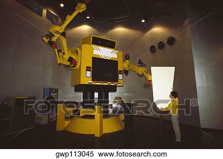 Stock Photography - Man operating a robot, Tokyo Prefecture, Japan. Fotosearch