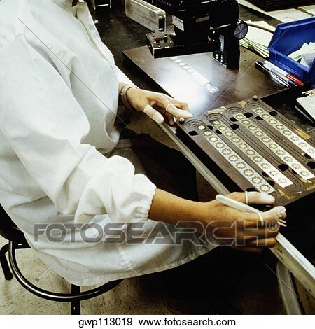 Mid section view of a man working in an electronic industry, Singapore View Large Photo Image Stock Photo - Mid section view of a man working in an electronic industry, Singapore. Fotosearch