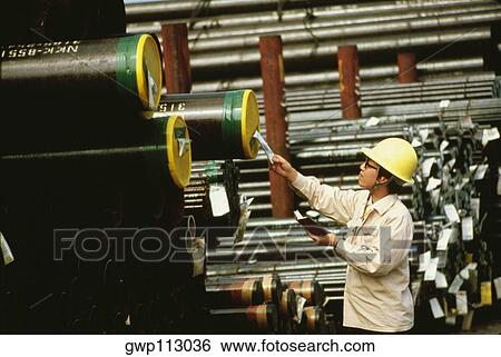 Stock Photograph - Side profile of a male worker inspecting at a steel mill, Kawasaki, Honshu, Japan. Fotosearch