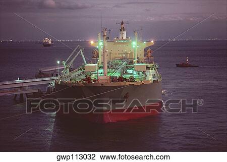 Stock Image - Supertanker unloading at a harbor, Osaka Prefecture, Japan. Fotosearch