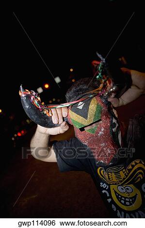 Close-up of a man wearing a mask View Large Photo Image Stock Photograph - Close-up of a man wearing a mask. Fotosearch