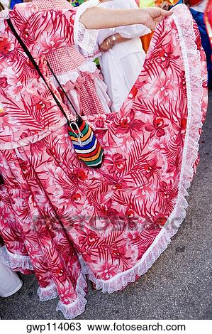 Stock Image - Close-up of a woman holding her costume. Fotosearch