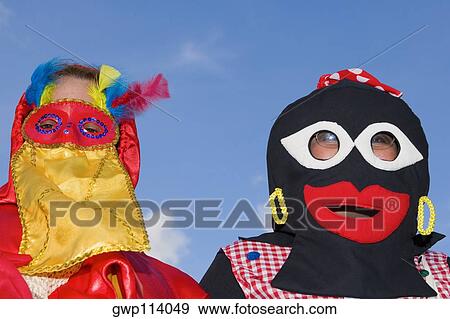 Close-up of two people wearing masks View Large Photo Image Stock Photo - Close-up of two people wearing masks. Fotosearch