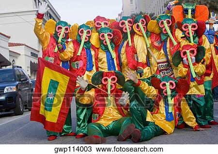 Stock Image - Group of people on the road wearing costumes. Fotosearch