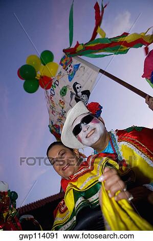 Low angle view of a mature couple wearing costumes and smiling View Large Photo Image Stock Image - Low angle view of a mature couple wearing costumes and smiling. Fotosearch