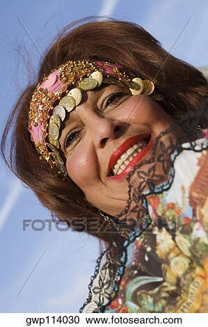 Low angle view of a mature woman smiling View Large Photo Image Stock Image - Low angle view of a mature woman smiling. Fotosearch