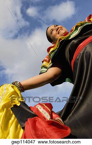 Low angle view of a mature woman wearing a costume and smiling View Large Photo Image Stock Photo - Low angle view of a mature woman wearing a costume and smiling. Fotosearch