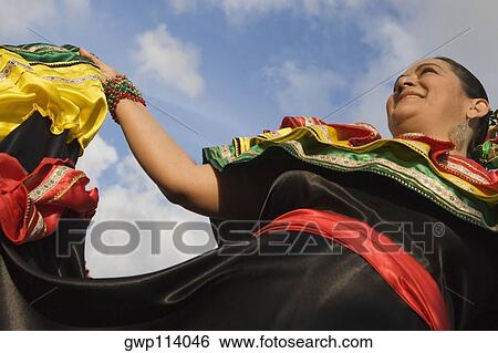 Low angle view of a mature woman wearing a costume and dancing View Large Photo Image Stock Photograph - Low angle view of a mature woman wearing a costume and dancing. Fotosearch