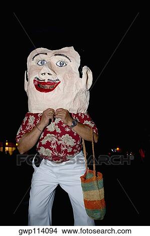 Man wearing a mask and standing View Large Photo Image Picture - Man wearing a mask and standing. Fotosearch