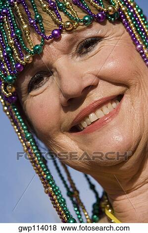 Portrait of a senior woman wearing a beaded headdress and smiling View Large Photo Image Stock Photo - Portrait of a senior woman wearing a beaded headdress and smiling. Fotosearch