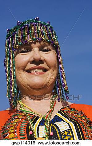 Portrait of a senior woman wearing a beaded headdress and smiling View Large Photo Image Stock Photograph - Portrait of a senior woman wearing a beaded headdress and smiling. Fotosearch