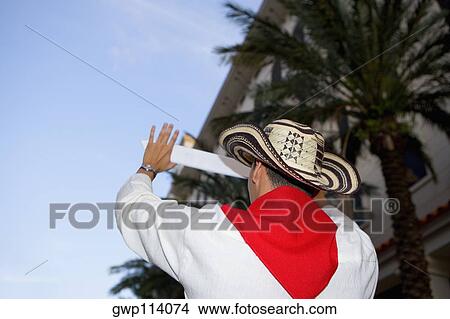 Rear view of a man gesturing with his hand View Large Photo Image Picture - Rear view of a man gesturing with his hand. Fotosearch