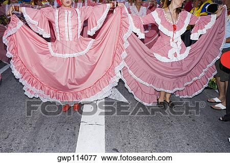 Two women wearing costumes and performing in a traditional festival View Large Photo Image Stock Photo - Two women wearing costumes and performing in a traditional festival. Fotosearch