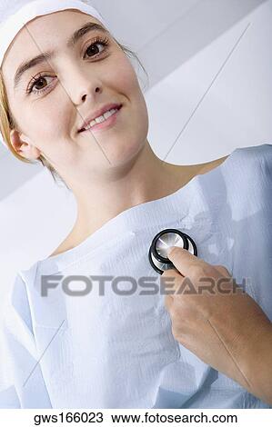 Close-up of a doctor's hand holding a stethoscope and examining a female patient View Large Photo Image Stock Image - Close-up of a doctor's hand holding a stethoscope and examining a female patient. Fotosearch