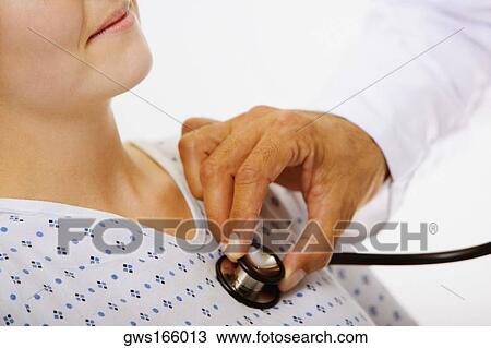 Close-up of a male doctor's hand examining a female patient with a stethoscope View Large Photo Image Stock Image - Close-up of a male doctor's hand examining a female patient with a stethoscope. Fotosearch