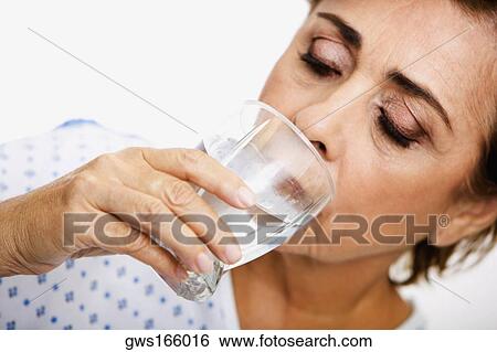 Close-up of a senior woman drinking water from a glass View Large Photo Image Stock Photograph - Close-up of a senior woman drinking water from a glass. Fotosearch