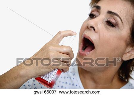 Close-up of a senior woman spraying mouthwash into her mouth View Large Photo Image Stock Photo - Close-up of a senior woman spraying mouthwash into her mouth. Fotosearch