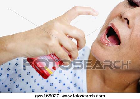 Close-up of a senior woman spraying mouthwash into her mouth View Large Photo Image Stock Photo - Close-up of a senior woman spraying mouthwash into her mouth. Fotosearch