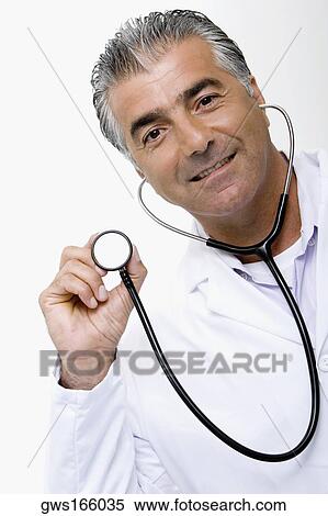 Portrait of a male doctor holding a stethoscope and smiling View Large Photo Image Stock Photography - Portrait of a male doctor holding a stethoscope and smiling. Fotosearch