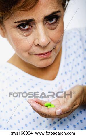 Portrait of a senior woman holding pills View Large Photo Image Picture - Portrait of a senior woman holding pills. Fotosearch