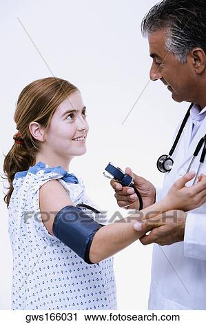 Side profile of a male doctor measuring blood pressure of a young woman View Large Photo Image Stock Image - Side profile of a male doctor measuring blood pressure of a young woman. Fotosearch