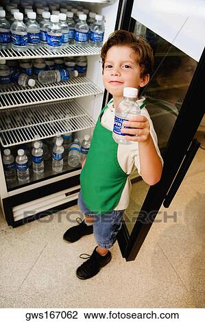 Stock Image - Boy holding a water bottle. Fotosearch