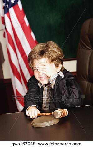 Boy imitating a judge View Large Photo Image Stock Photo - Boy imitating a judge. Fotosearch