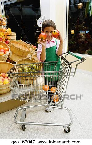 Boy standing and holding two pomegranates View Large Photo Image Stock Photo - Boy standing and holding two pomegranates. Fotosearch