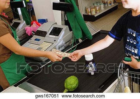 Close-up of a boy paying cash at the checkout counter at a store View Large Photo Image Stock Image - Close-up of a boy paying cash at the checkout counter at a store. Fotosearch