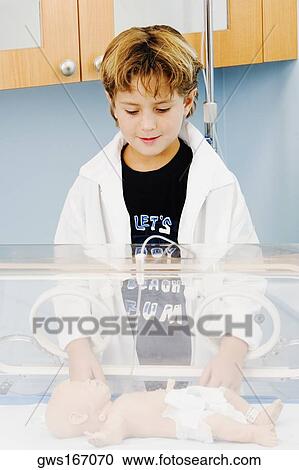Close-up of a boy standing near an incubator View Large Photo Image Stock Image - Close-up of a boy standing near an incubator. Fotosearch
