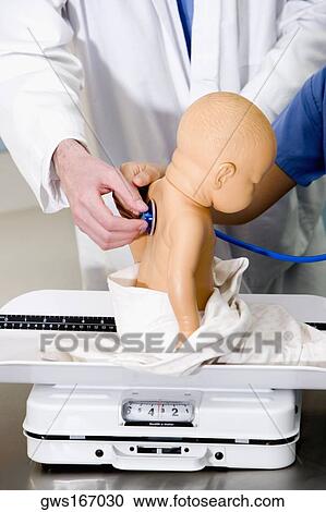 Close-up of a doll on a weighing scale being examined by a doctor with a stethoscope View Large Photo Image Stock Image - Close-up of a doll on a weighing scale being examined by a doctor with a stethoscope. Fotosearch