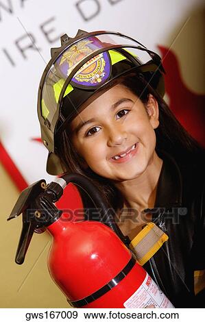 Close-up of a girl holding a fire extinguisher View Large Photo Image Stock Photo - Close-up of a girl holding a fire extinguisher. Fotosearch