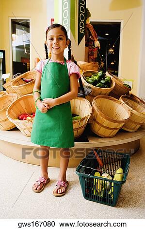 Girl standing in a store and smiling View Large Photo Image Stock Image - Girl standing in a store and smiling. Fotosearch