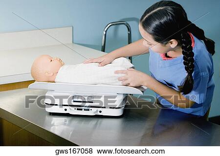 Stock Photo - Girl weighing a doll on a weighing scale. Fotosearch