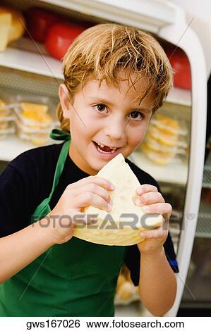 Stock Photograph - Portrait of a boy eating cheese. Fotosearch