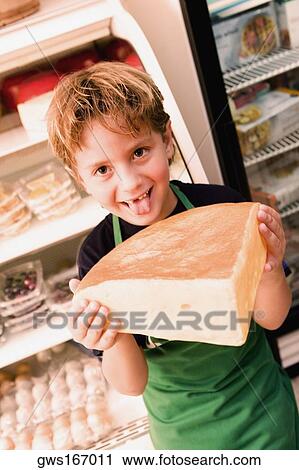 Portrait of a boy holding cheese and sticking his tongue out View Large Photo Image Stock Image - Portrait of a boy holding cheese and sticking his tongue out. Fotosearch