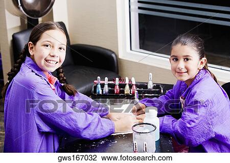 Portrait of a girl giving her sister a manicure View Large Photo Image Stock Image - Portrait of a girl giving her sister a manicure. Fotosearch