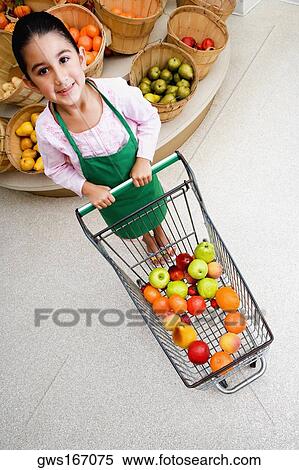 Portrait of a girl holding a shopping cart and smiling View Large Photo Image Stock Photography - Portrait of a girl holding a shopping cart and smiling. Fotosearch