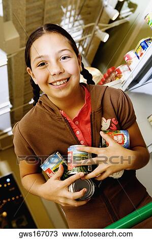 Portrait of a girl holding cans and smiling View Large Photo Image Stock Image - Portrait of a girl holding cans and smiling. Fotosearch