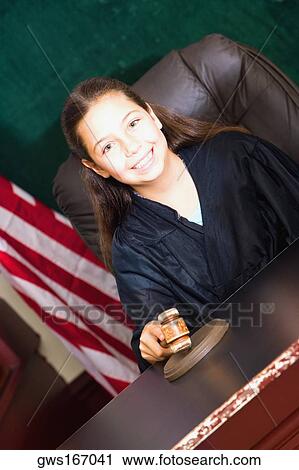 Stock Image - Portrait of a girl pretending to be a judge. Fotosearch