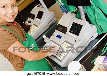 Portrait of a girl using a cash register at the checkout counter and smiling View Large Photo Image Stock Photography - Portrait of a girl using a cash register at the checkout counter and smiling. Fotosearch