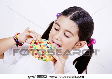 Close-up of a girl eating a pie View Large Photo Image Stock Image - Close-up of a girl eating a pie. Fotosearch