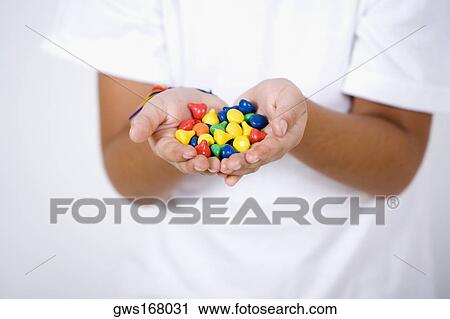 Close-up of a girl's hands holding candies View Large Photo Image Stock Image - Close-up of a girl's hands holding candies. Fotosearch