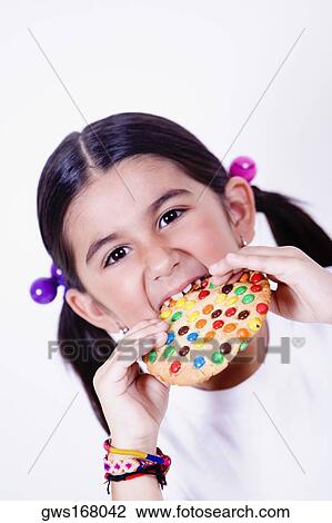 Portrait of a girl eating a donut View Large Photo Image Stock Image - Portrait of a girl eating a donut. Fotosearch