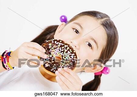 Portrait of a girl holding a donut View Large Photo Image Stock Photo - Portrait of a girl holding a donut. Fotosearch