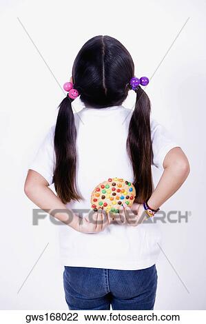 Rear view of a girl holding a pie behind her back View Large Photo Image Stock Image - Rear view of a girl holding a pie behind her back. Fotosearch