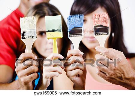 Close-up of four people's hands holding paintbrushes View Large Photo Image Stock Photography - Close-up of four people's hands holding paintbrushes. Fotosearch
