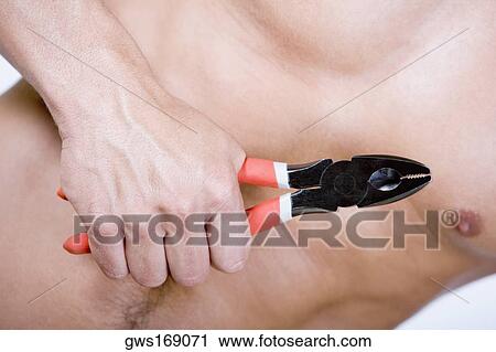 Mid section view of a man holding pliers View Large Photo Image Stock Image - Mid section view of a man holding pliers. Fotosearch