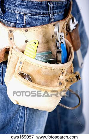 Mid section view of a man wearing a tool belt View Large Photo Image Stock Photo - Mid section view of a man wearing a tool belt. Fotosearch