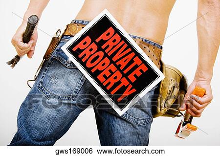 Mid section view of a man wearing a tool belt with a Private Property sign View Large Photo Image Stock Photograph - Mid section view of a man wearing a tool belt with a Private Property sign. Fotosearch
